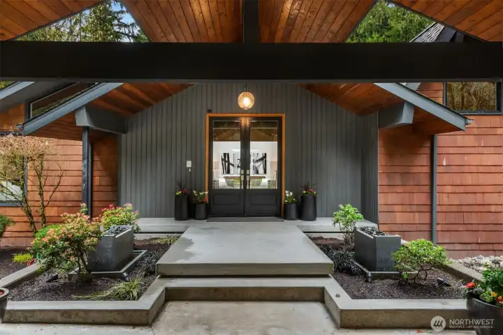 Inviting entry with double doors, fountains and landscape
