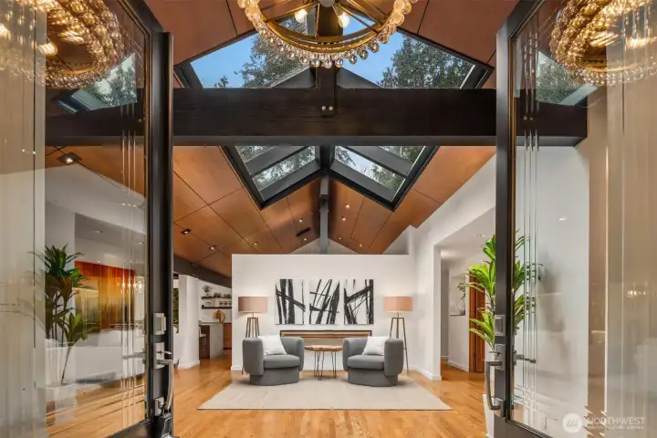 Grand entry with vaulted ceilings and custom glass skylight