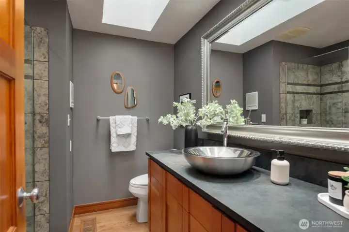 Main Bathroom with frameless glass shower, fir cabinetry, vessel sink and slate slab countertops