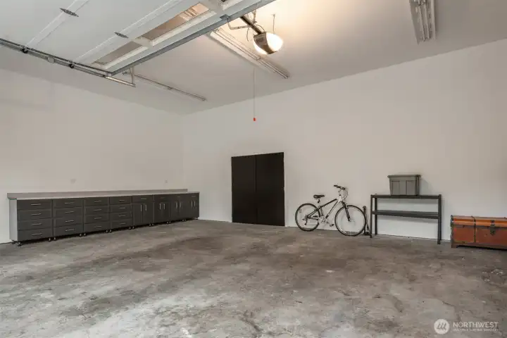 Spacious garage with room for vehicles, toys, storage and workspace