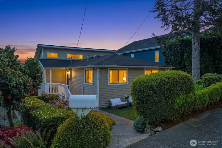 A sweet front yard and covered porch welcomes you to this solid solid reimagined 1914 classic West Seattle view home.