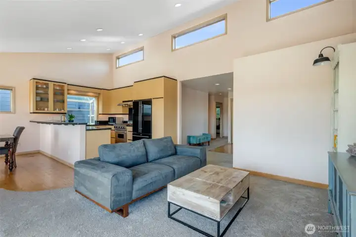 An open floor plan with vaulted ceilings and transom windows.