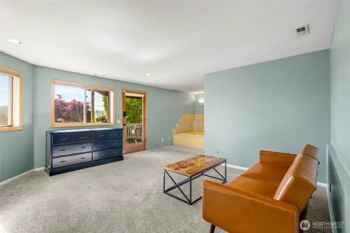 A light and bright lower level. Previously used as a sumptuous primary suite, with a jet tub, full bathroom and sauna.