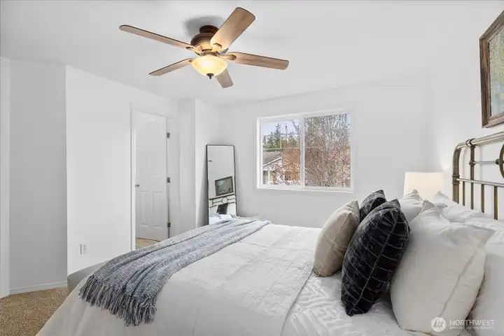 Ceiling fan and large window brings in natural light.