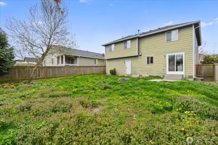 The private backyard is a blank slate, ready for your vision and fully fenced!