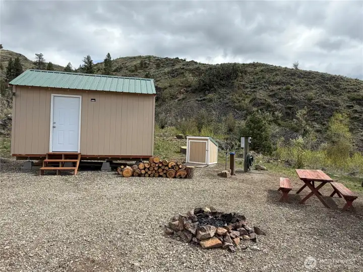The fire pit and picnic table provide a great spot to enjoy the outdoors!
