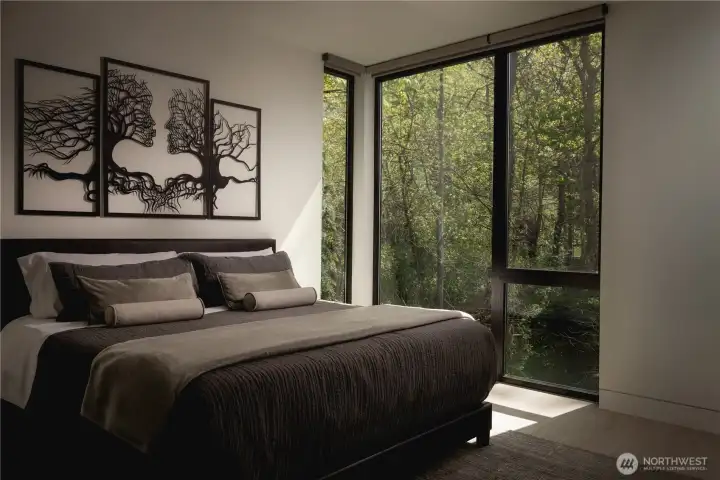 The guest suite rests in a tucked-away setting, where the surrounding trees create a sense of privacy.