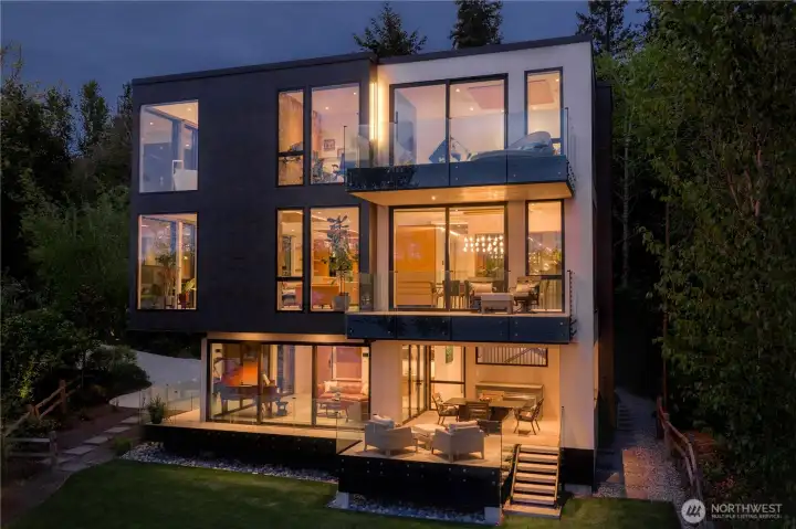 At dusk, the architecture reveals itself in layers of light and transparency.