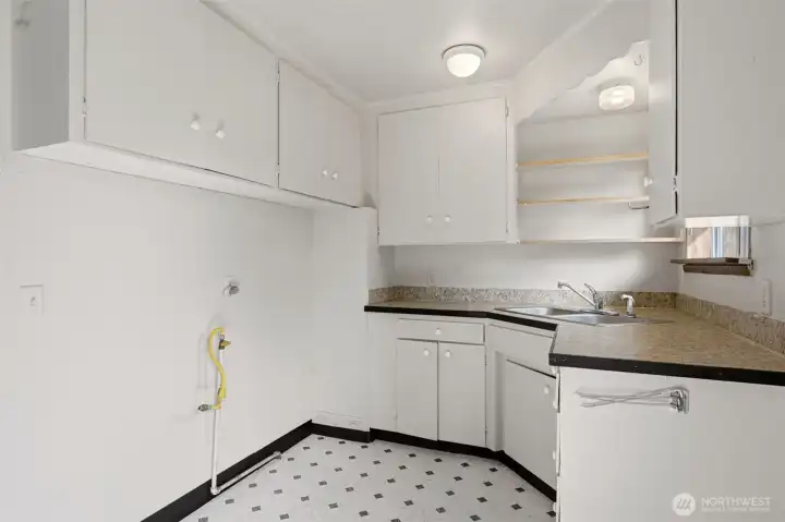 This kitchen view shows the location for range and refrigerator. Appliances to be supplied by buyer.