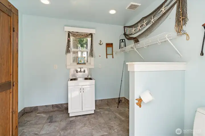 A boat house gives everyone a chance to clean off after a dip in the canal: Find laundry hookups, a half bath, and a place for all your beach toys. A boat house gives everyone a chance to clean off after a dip in the canal: Find laundry hookups, a half bath, and a place for all your beach toys.