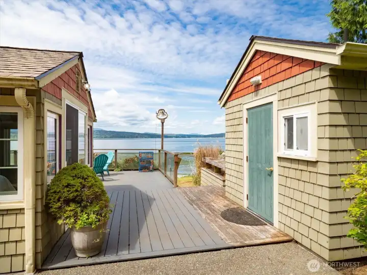 From the back patio, a view of Hood Canal, the boat house and the primary bedroom. From the back patio, a view of Hood Canal, the boat house and the primary bedroom.