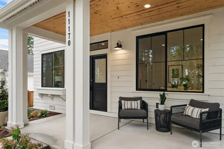 Welcoming covered patio with greenbelt views