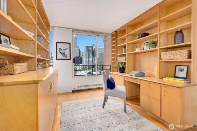 Experience a delightful study with a fully-equipped office featuring expansive hardwood built-ins, crafted with integrity and thoughtful design.