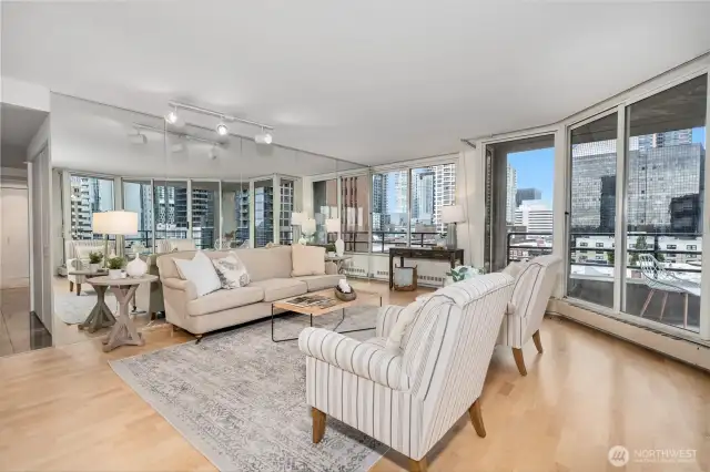 An expansive living room featuring classic hardwood floors throughout.
