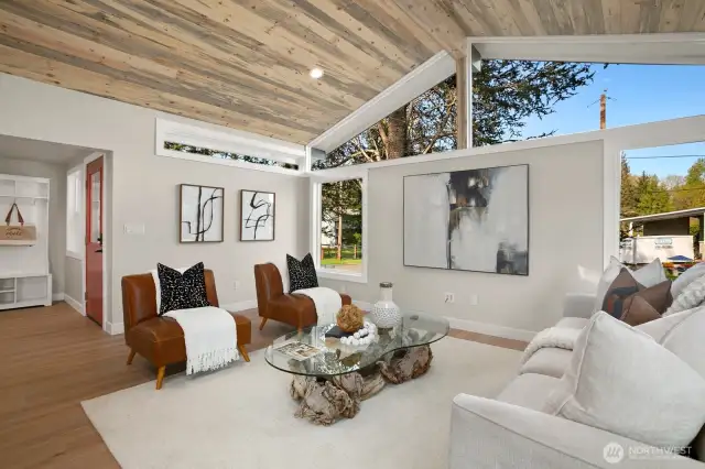 Open concept living room with large custom windows with Mt Si views