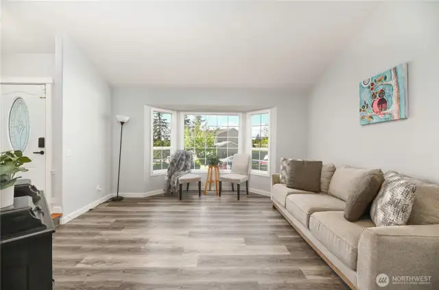 Wood laminate flooring throughout and newer carpeting on the stairs.