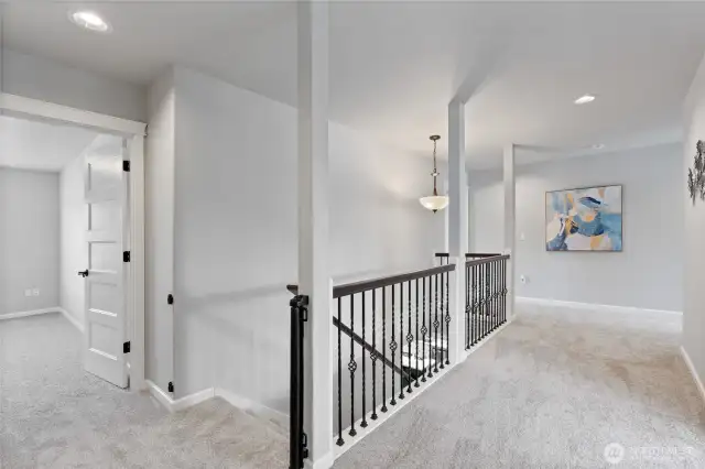 Landing at the top of the stairs. Wide hallways make for easy access to all the upstairs spaces.