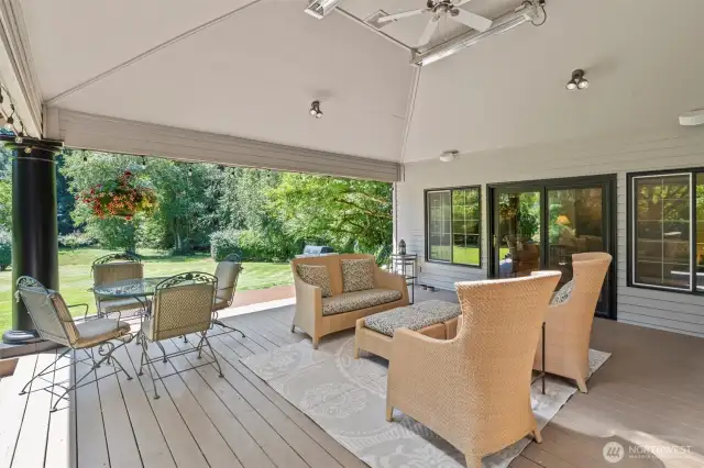 Sliding glass doors off both the family room and the primary suite open to this spectacular, 420-square-foot covered and heated deck—seamlessly blending indoor comfort with outdoor living. Vaulted ceilings with skylights, a ceiling fan, and built-in speakers enhance the ambiance, while thoughtful design ensures year-round comfort. Whether you're sipping your morning coffee, relaxing in the shade, grilling with friends, or hosting a crowd, this impressive extension of the home is fully equipped for it all. The current owners even hosted a wedding with 175 guests clearly demonstrating how well this deck and property accommodate both peaceful moments to hosting grand celebrations.