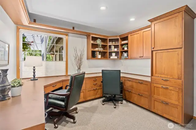 This well-appointed office offers abundant storage and functional workspace with two built-in workstations, custom cabinetry, shelving, and a closet. It’s an ideal setting for focused work, creative projects, or quiet study.