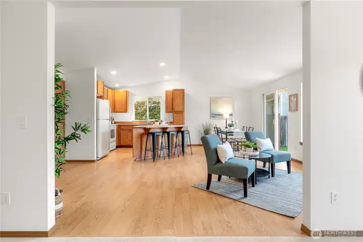 Spacious open kitchen w/dining area, cozy seating by gas insert, & slider to backyard