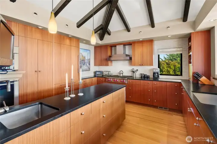 This beautiful kitchen is highly functional and room for everyone. Notice the pretty beams and vaulted ceiling.