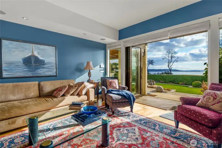 The lower level features an handsome family room that spills out to the backyard. Check out that view! Lovely patio with heaters is just a few steps away to your left.