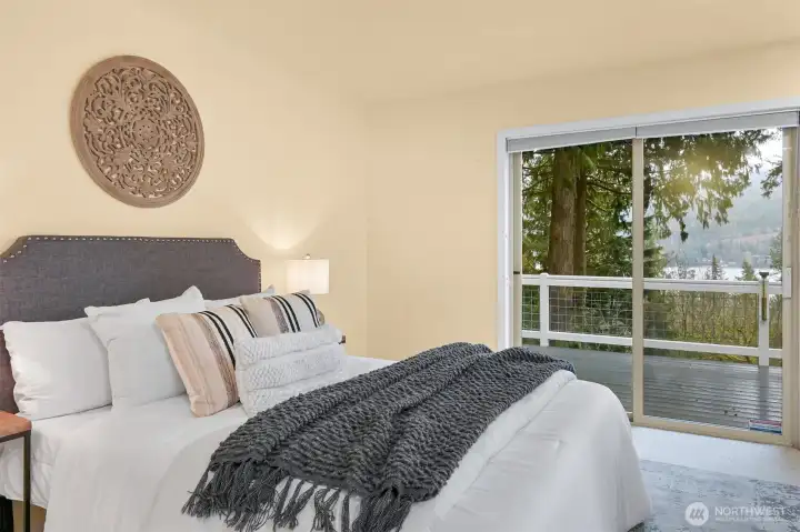 The primary suite, off the living room, stuns with lake views and deck access.