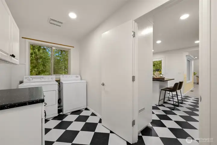 Laundry room is situated between kitchen and garage