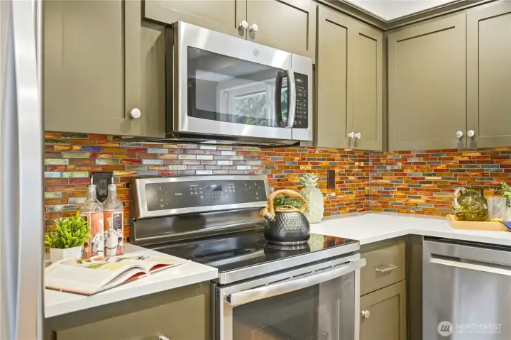 Note the artistic tile backsplash adding color to the kitchen!