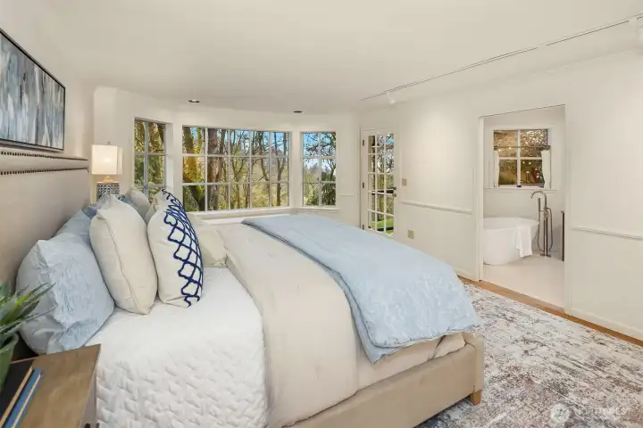 This palatial primary bedroom has space for everything, plus a walk-in closet!