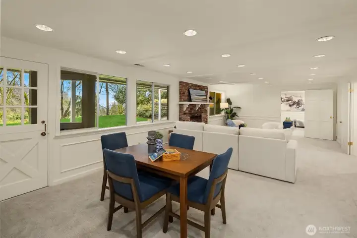 A wall of windows graces this spacious family room, with an exterior door for easy access to the backyard.