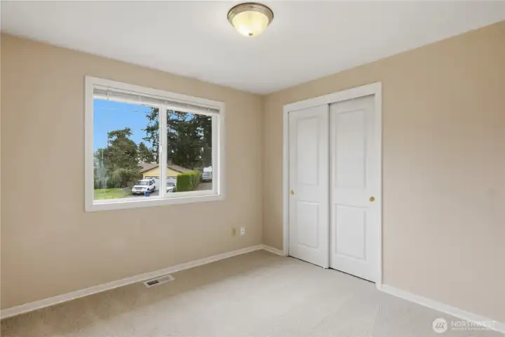 Bedroom or home office with natural light and closet.