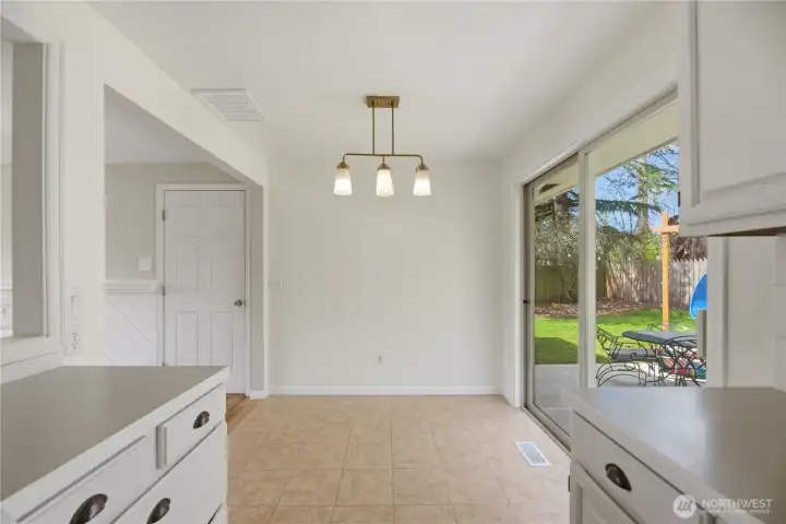 Dining area with slider to private backyard and patio.