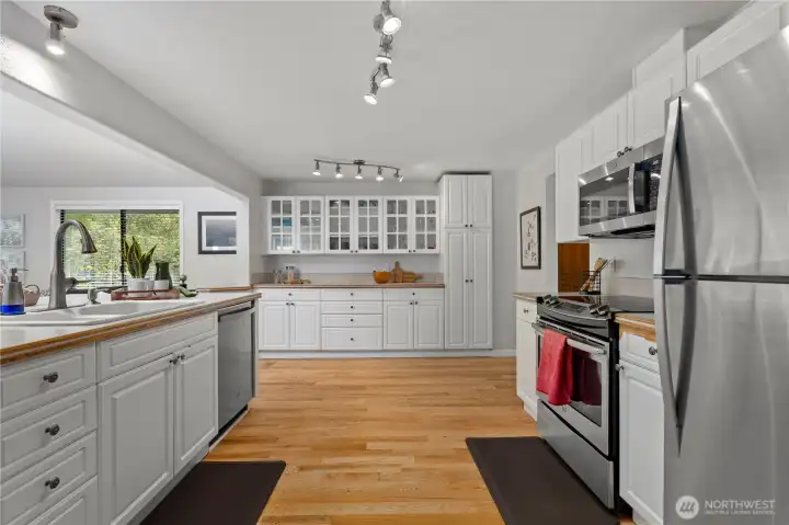 The dining room connects to a generous kitchen, with eat-in space, that overlooks the sunroom and the backyard.