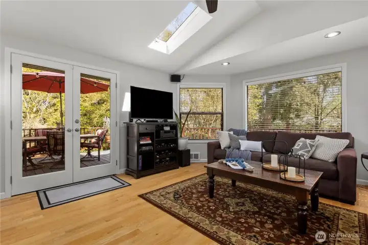 French doors open to the upper-level deck with beautiful views of the grounds.