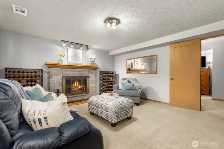 Lower-level family room. The door on the right of the frame leads to the primary suite.