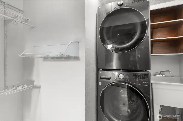 The lower-level laundry room with utility sink is conveniently located near the primary suite. LG washer and dryer were purchased in 2024 and are included.