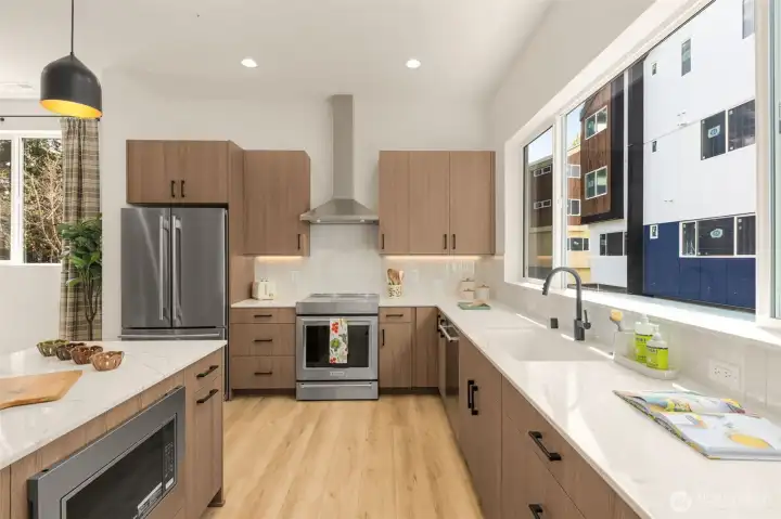 Quartz countertops, tile backsplash. Photo is of model home of same floorplan. Color schemes and finishes will vary per plan. Quartz countertops, tile backsplash. Photo is of model home of same floorplan. Color schemes and finishes will vary per plan.