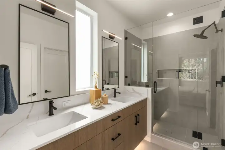 Primary ensuite bath room has dual sink vanity, under cabinet lighting (motion activated) and large shower. Photo is of model home of same floorplan. Color schemes and finishes will vary per plan. Primary ensuite bath room has dual sink vanity, under cabinet lighting (motion activated) and large shower. Photo is of model home of same floorplan. Color schemes and finishes will vary per plan.