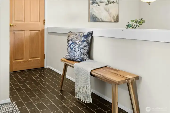 Tiled entry opens to the living and dining room. Door leads into the attached 2 car garage.
