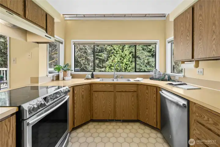 Efficient U-shaped kitchen connected to the family room.