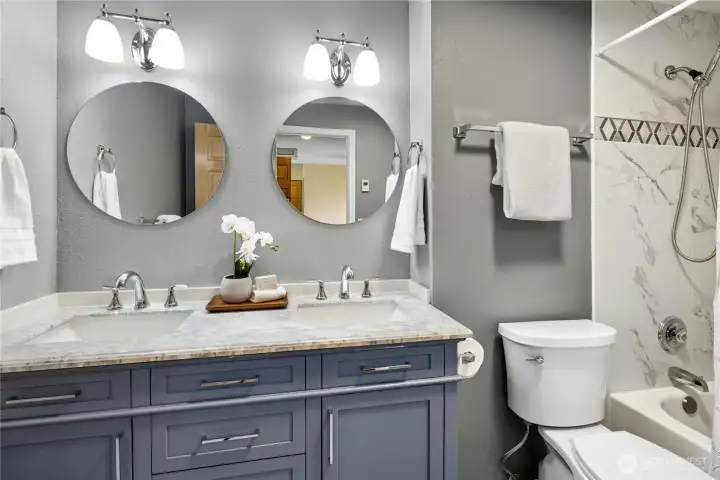 The lovely updated bath has a new dual vanity and fixtures plus a heated floor.