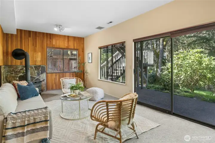 On the lower level there is a flexible rec room with wood stove and slider out to the backyard.