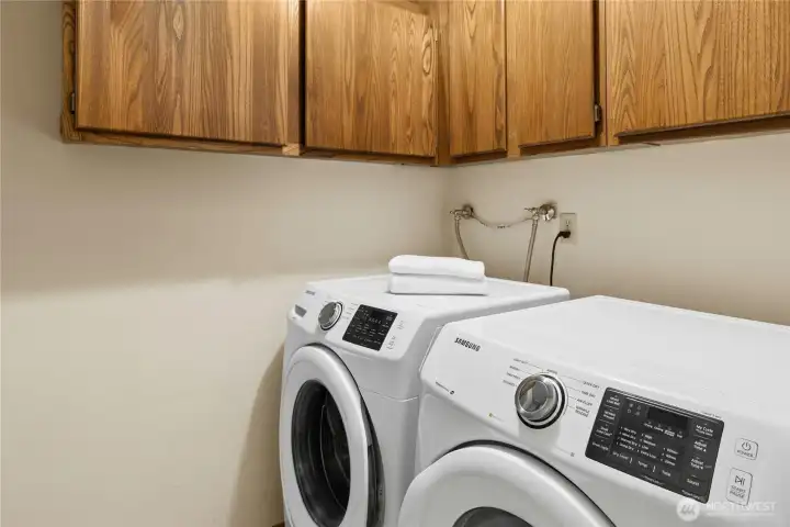 The laundry room is next to the bedroom area.