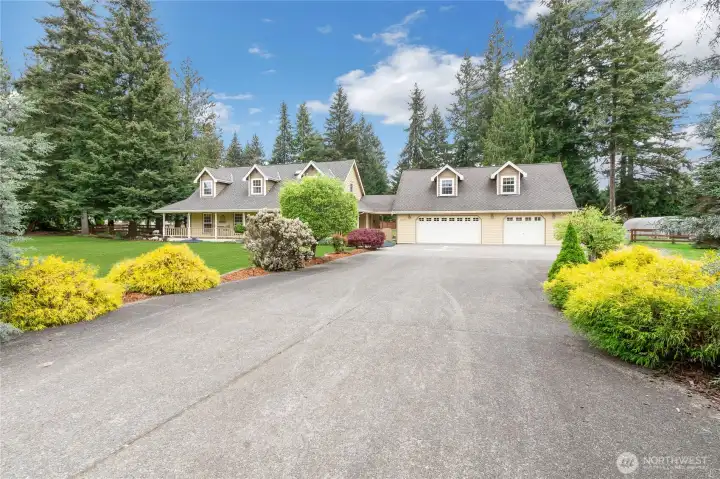 Long flat driveway with beautiful mature landscaping