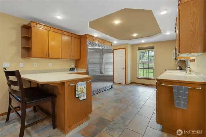 Breakfast bar, stainless steel Electrolux induction double oven range, Electrolux built in refrigerator and freezer, convection oven/microwave. Kitchen Aide dishwasher. 2 pantries. Solid oak cabinets. Ceramic tile floors.