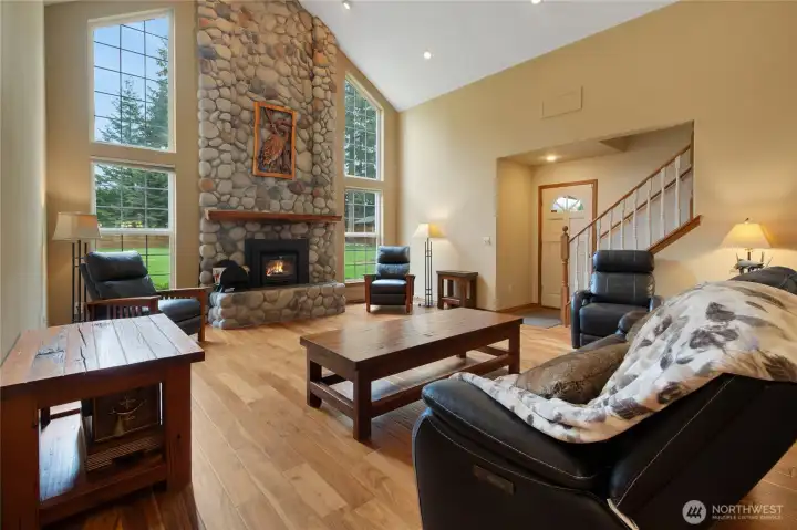 Living room with view of door to back deck and covered breezeway.  Stairs lead up to two bedrooms and bonus loft area, full bath too.