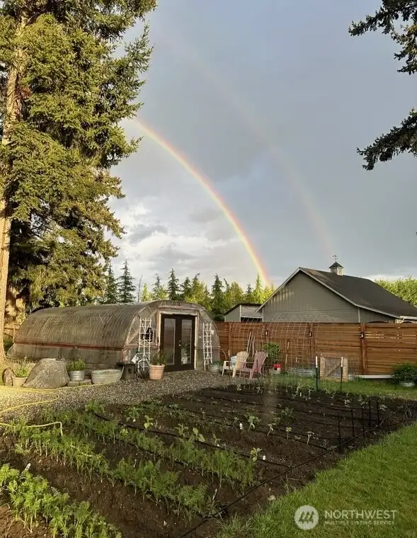 Custom Greenhouse with amazing growing space inside and outside beds. Fruit trees too.