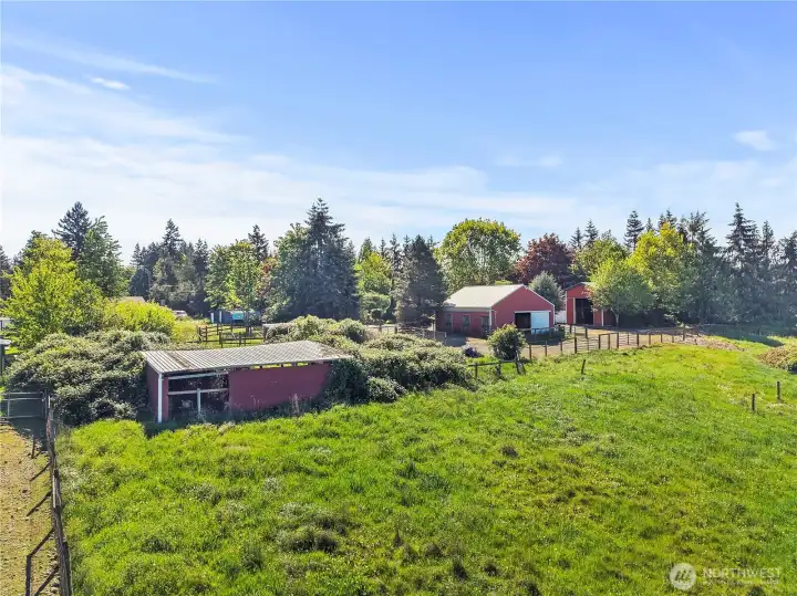 old building on left with barn in the middle then RV garage on the right.