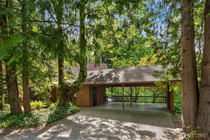 The driveway extends to the expansive covered parking/outdoor entertaining area.